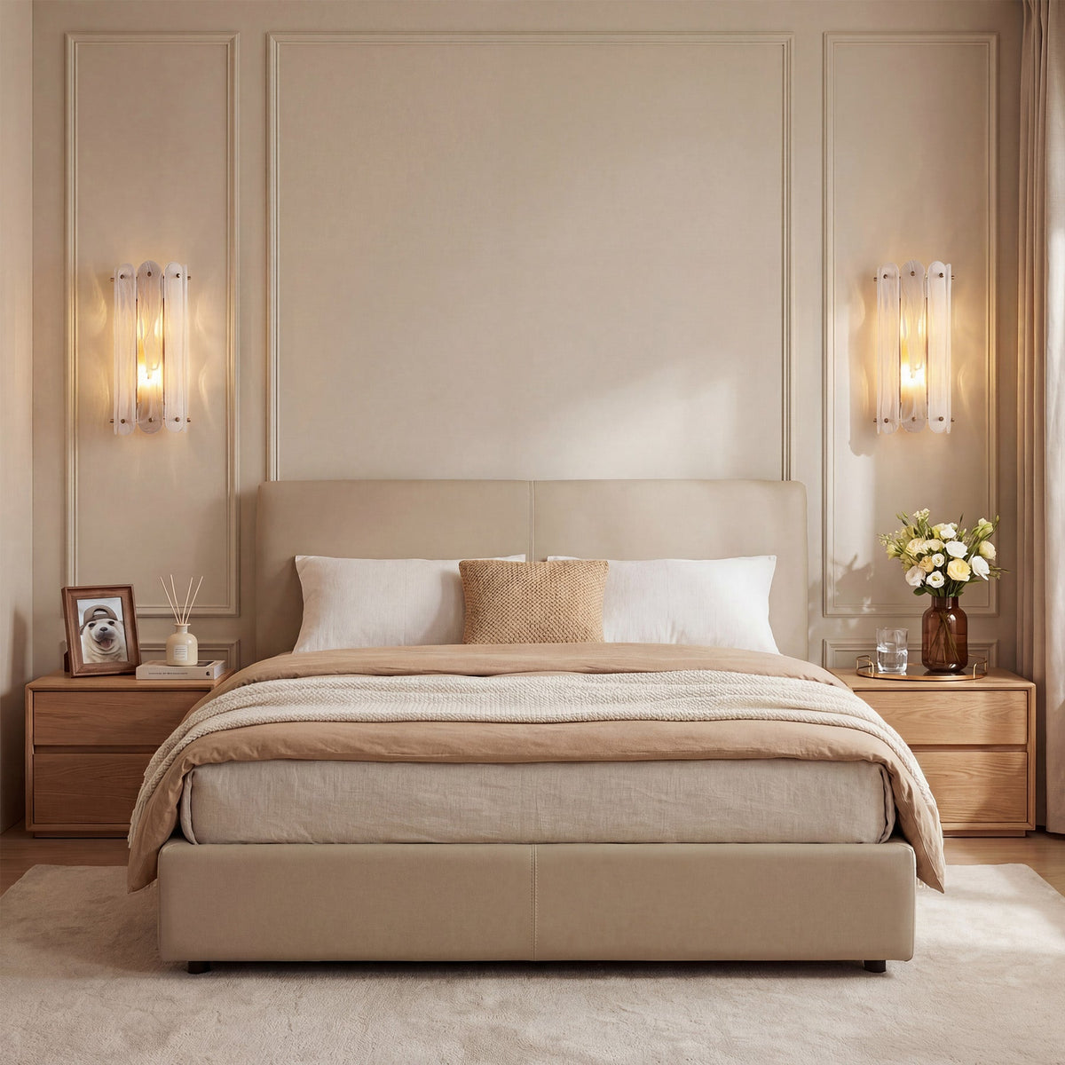 Two brass wall sconces with cloud glass shades mounted on beige wall above bed