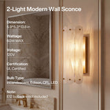 Brass wall sconce with cloud glass shades, lit, mounted on bathroom wall beside mirror, 5.9x5.3x13.8 in