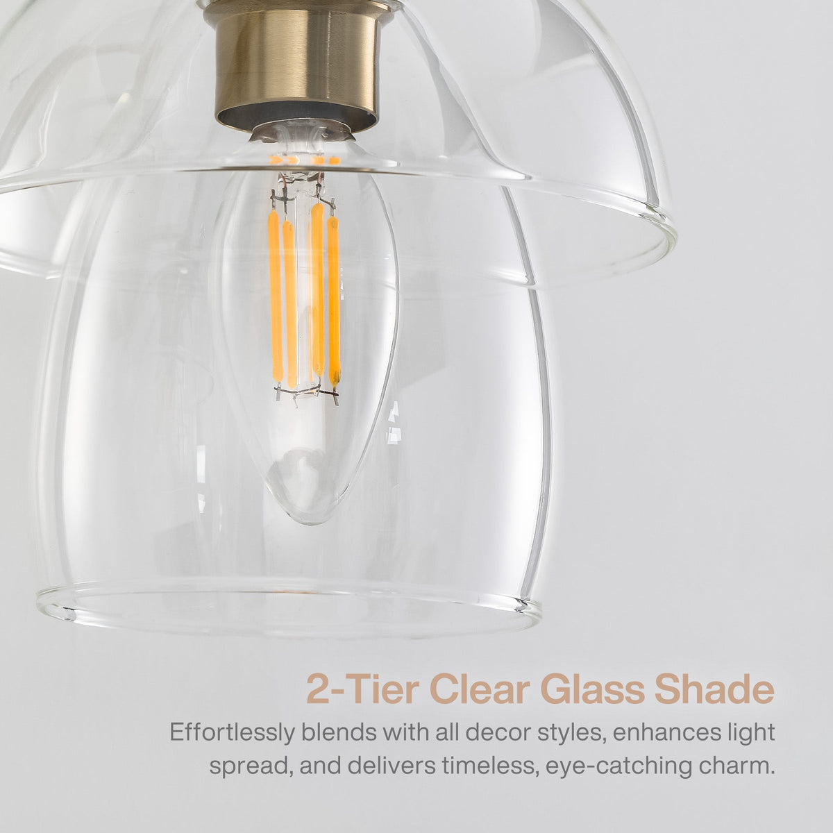 Close-up of gold bathroom vanity light with clear glass shades and LED bulb