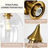 Close-up of gold pendant light's ceramic base and tiered clear glass shade