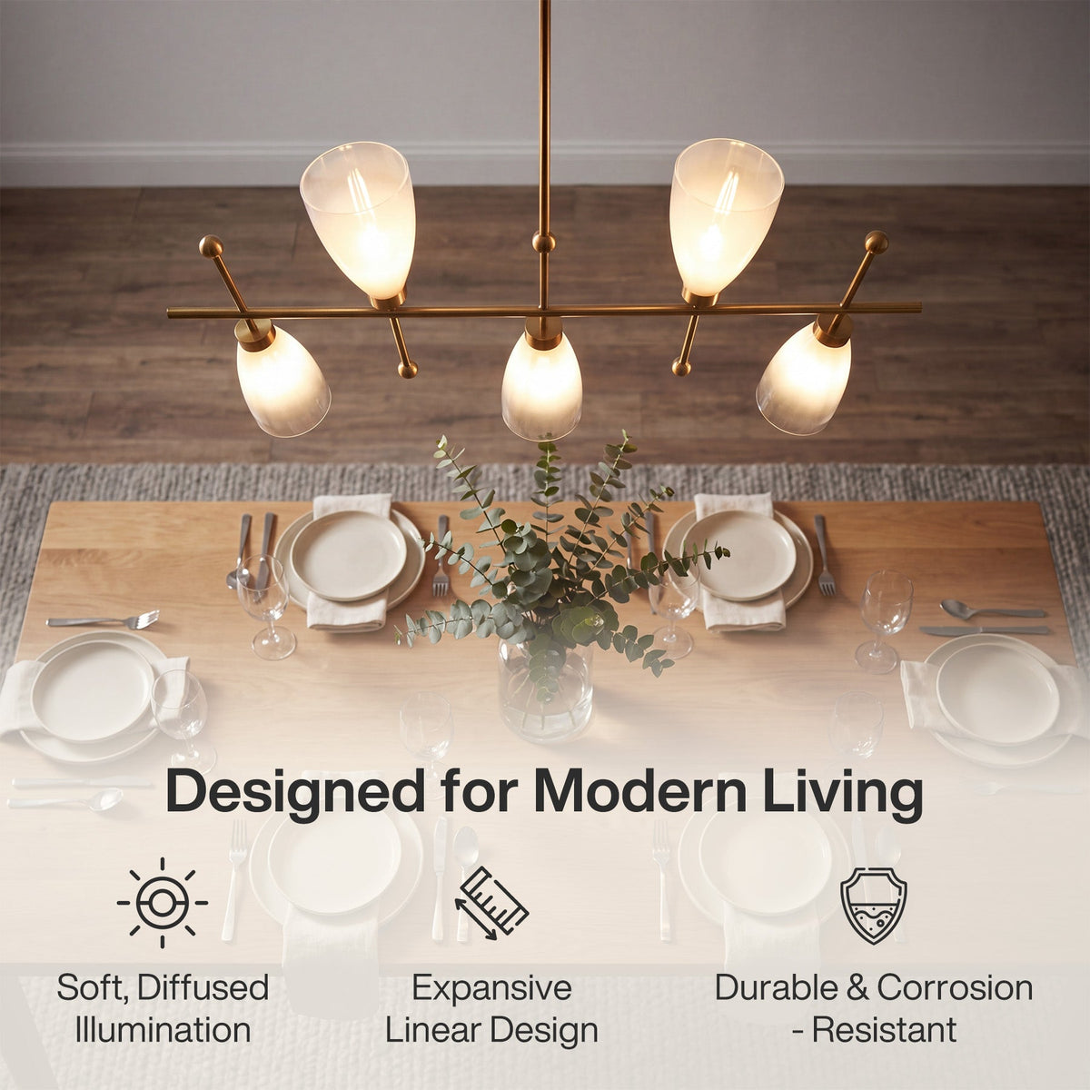 Five-light brushed brass linear chandelier with gradient frosted glass, overhead view over dining table