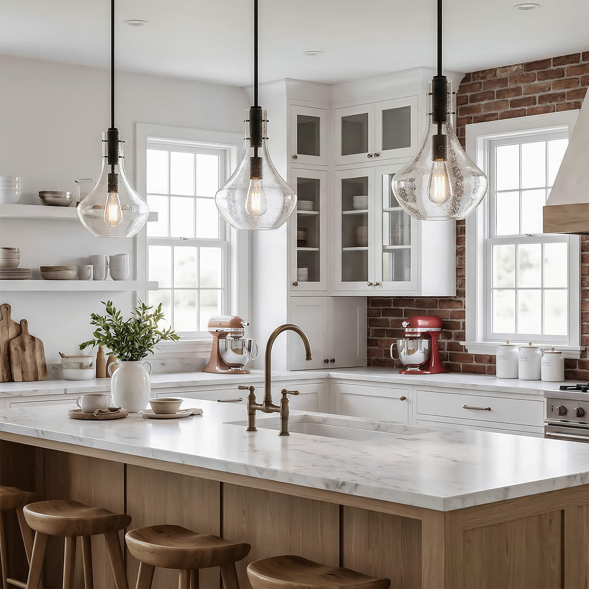 Three black mini pendant lights with bubble glass shades hang over a kitchen island