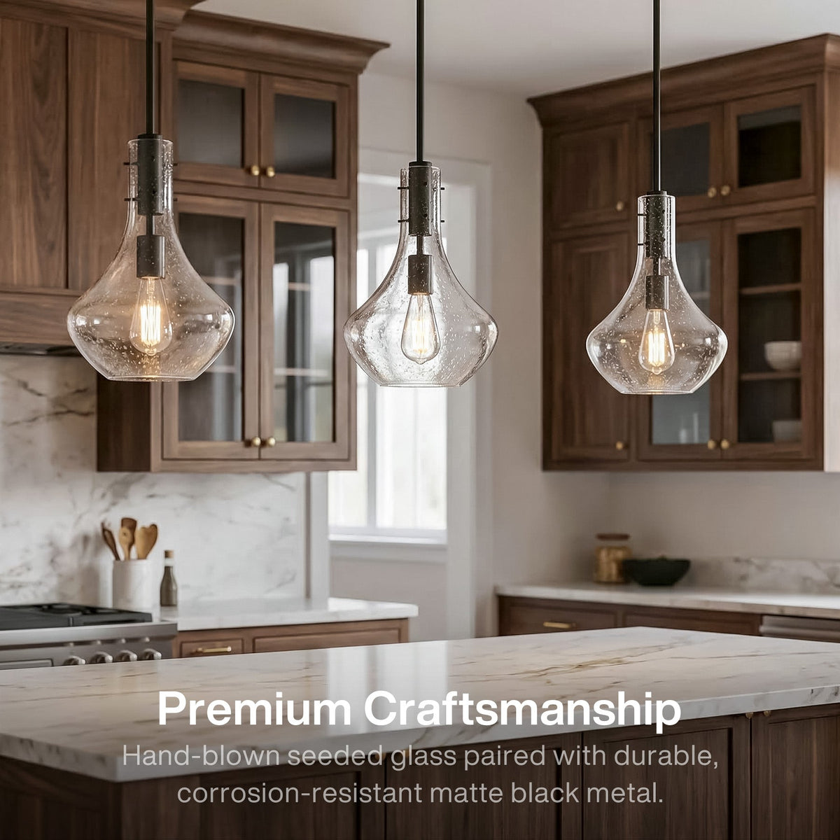 Three black mini pendant lights with bubble glass shades hanging over a kitchen island