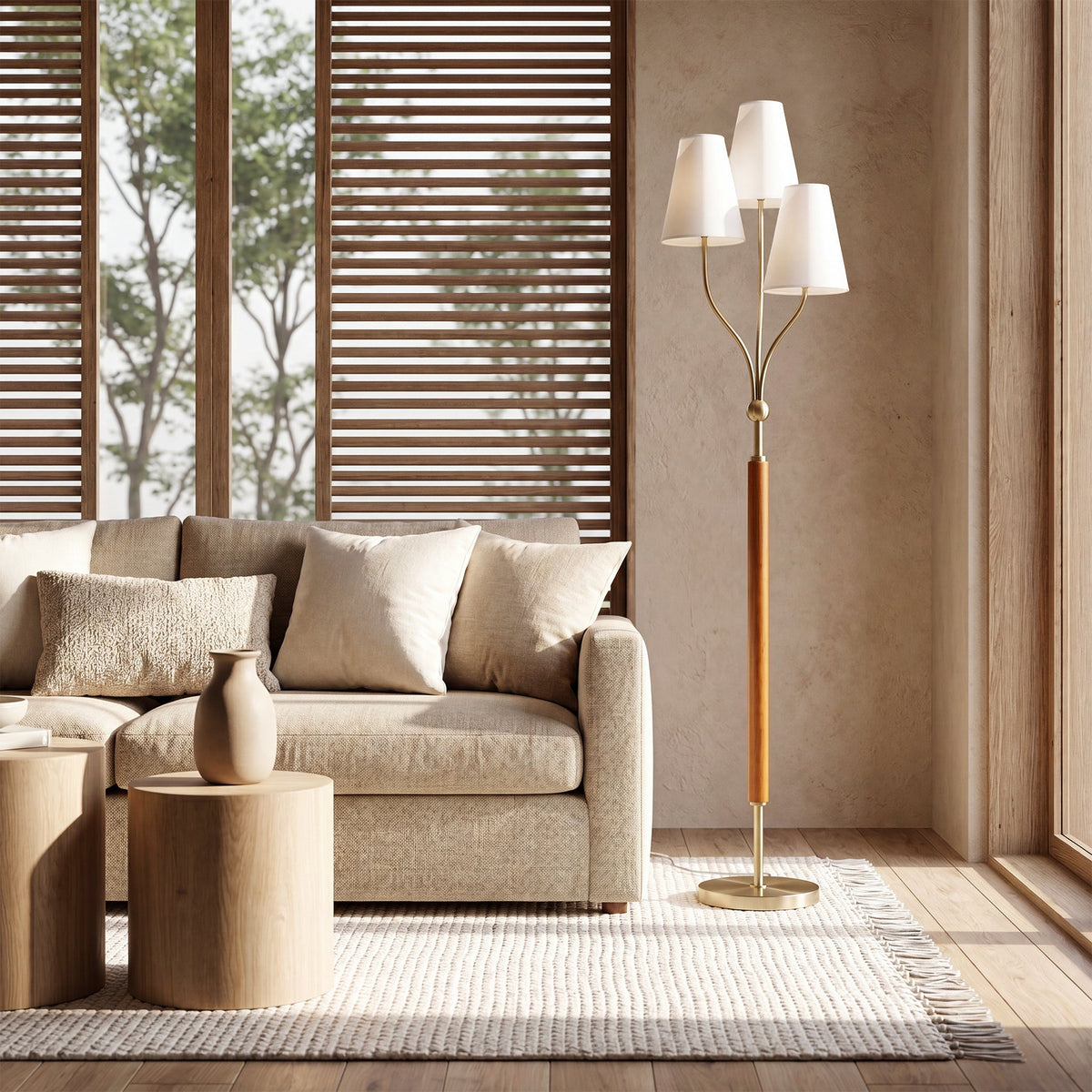 Gold three-head floor lamp with linen shades and rubberwood handle, shown in a living room setting