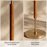 Close-up of gold-plated metal base and natural rubberwood lamp handle