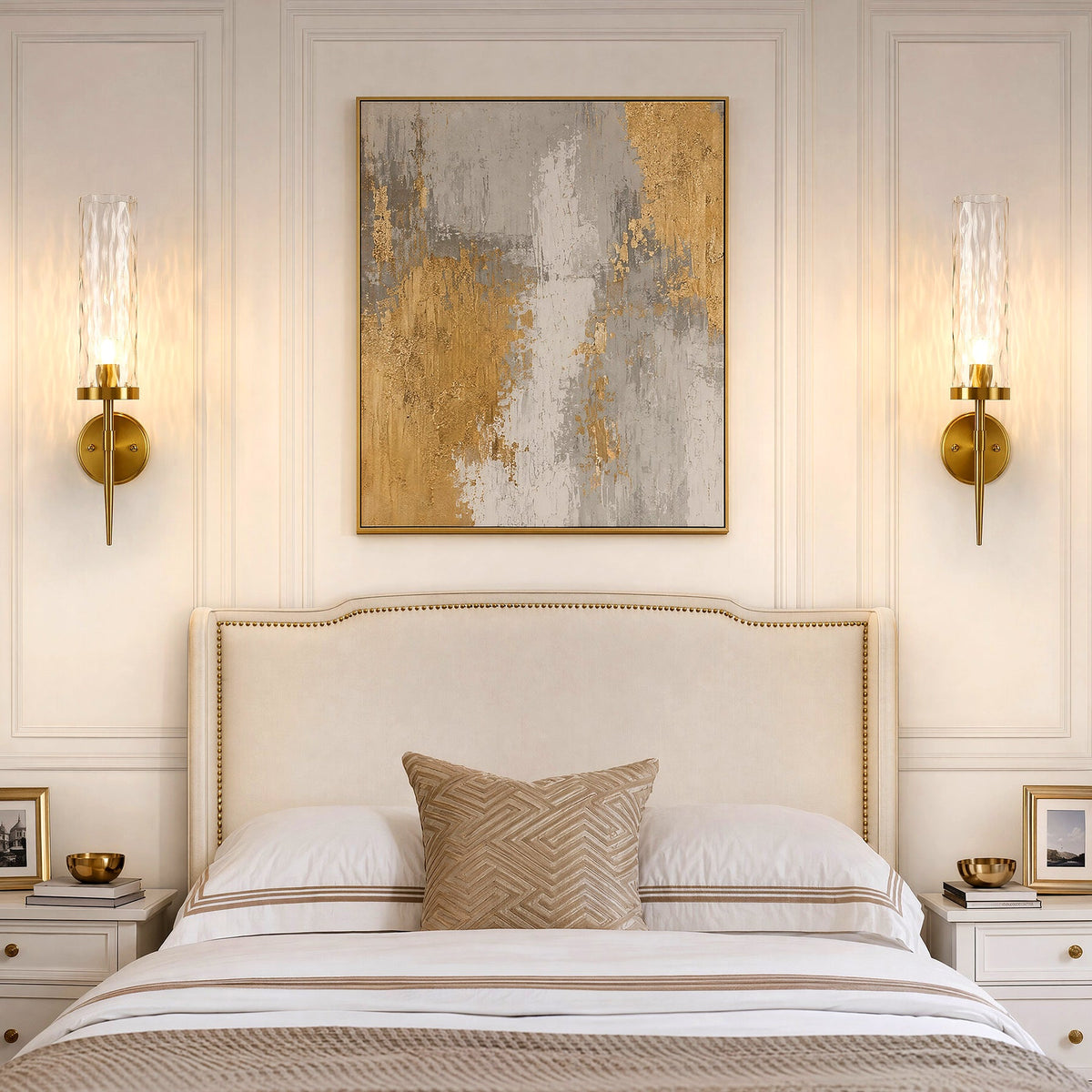 Two gold wall sconces with water ripple glass, mounted on bedroom wall flanking a bed