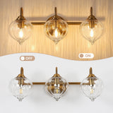 Gold bathroom vanity light with three pumpkin-shaped glass shades, shown on and off