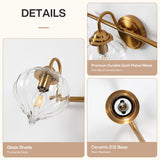 Gold bathroom vanity light with pumpkin-shaped glass shades, shown at an angle