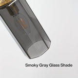 Close-up of a smoky gray glass shade on a gold chandelier, angled view