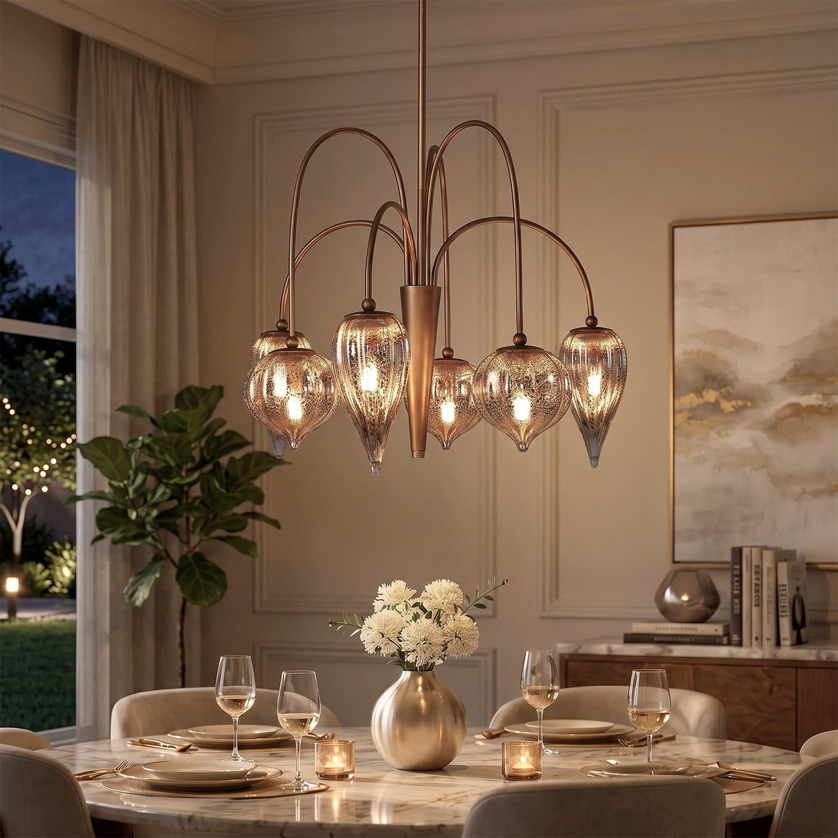 Antique brass chandelier with six mercury glass shades hanging over a dining table