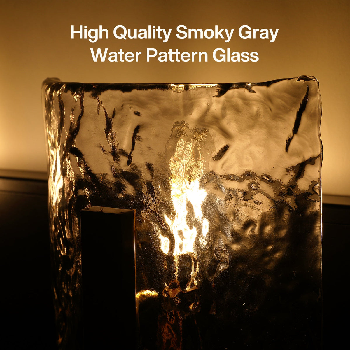 Three-light brass vanity light with smoky gray ripple glass, shown from front angle