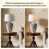 Blue and white porcelain table lamp with burlap shade on wooden side table in living room